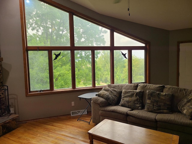 living room with light wood-style floors and visible vents