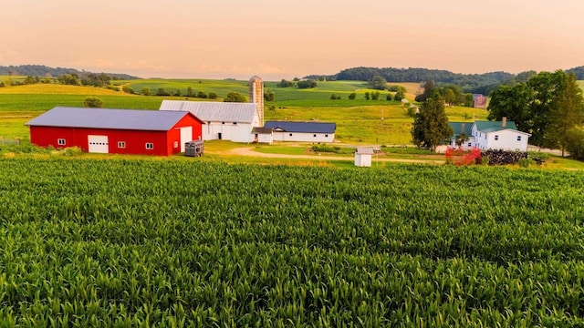 yard at dusk with an outdoor structure and a rural view