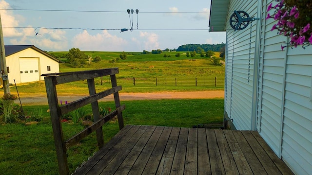 wooden deck with a rural view and a lawn