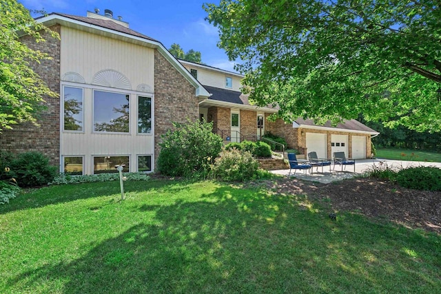 view of front of home featuring a garage and a front lawn