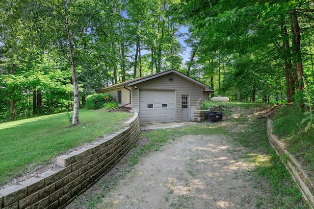 view of side of home with a yard and a garage