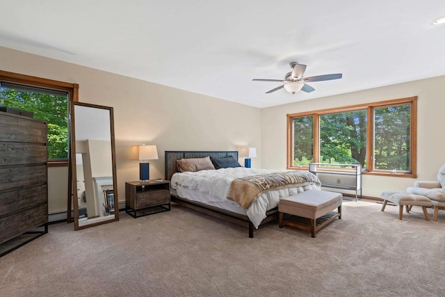 carpeted bedroom featuring baseboard heating and ceiling fan