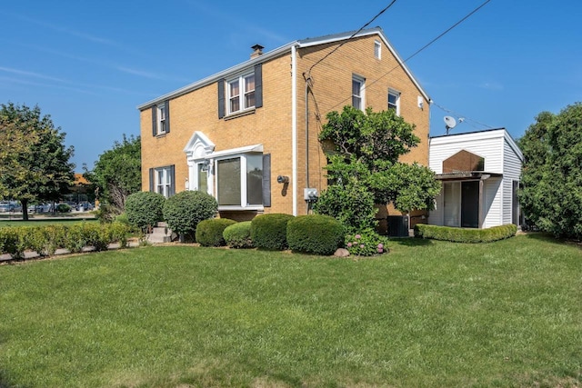 rear view of house with a lawn