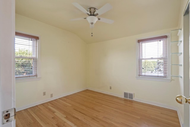 unfurnished room with ceiling fan, plenty of natural light, lofted ceiling, and light hardwood / wood-style floors