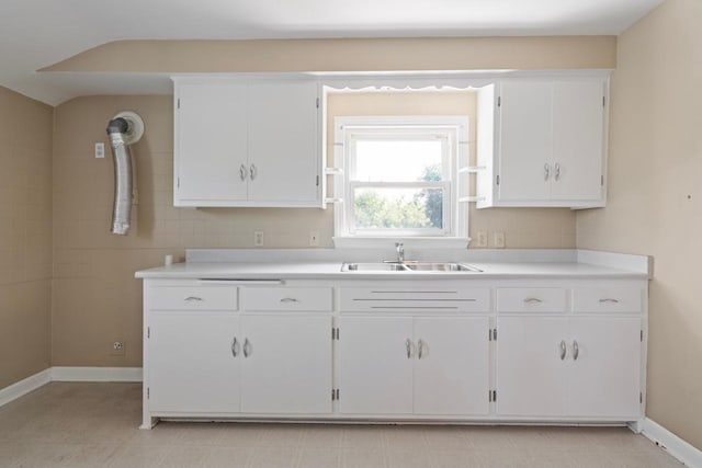 kitchen featuring white cabinetry and sink