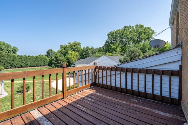 wooden terrace with a lawn