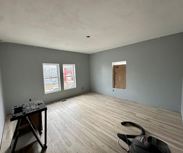 unfurnished room with light hardwood / wood-style floors