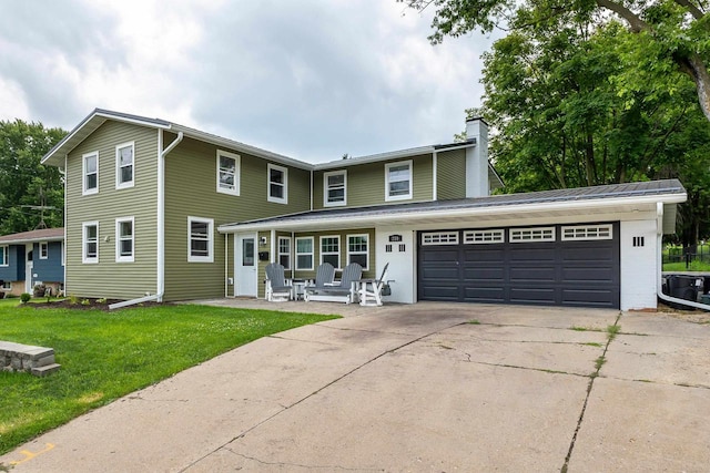 view of front property featuring a garage and a front lawn