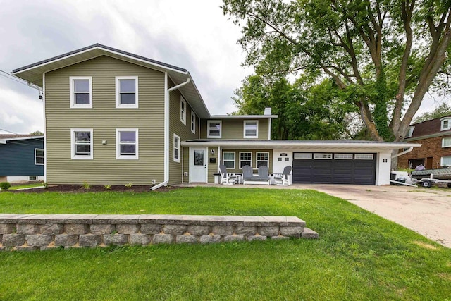 view of front of home featuring a garage and a front lawn