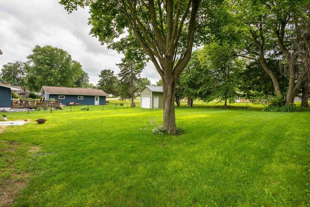 view of yard featuring a garage and an outdoor structure