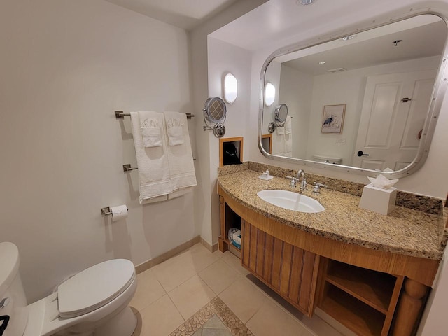 bathroom featuring vanity, toilet, and tile patterned floors