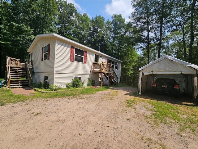 view of front of property featuring a carport and a deck