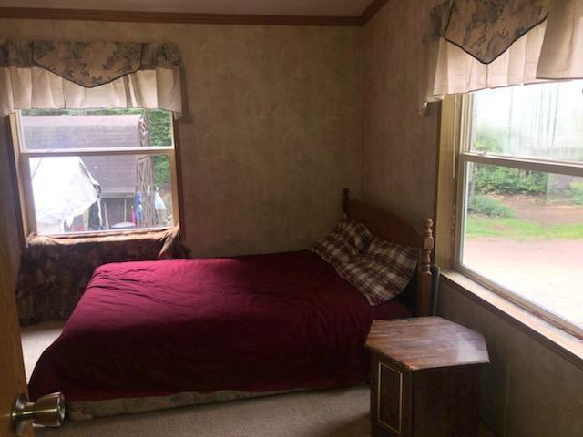 bedroom featuring multiple windows and crown molding