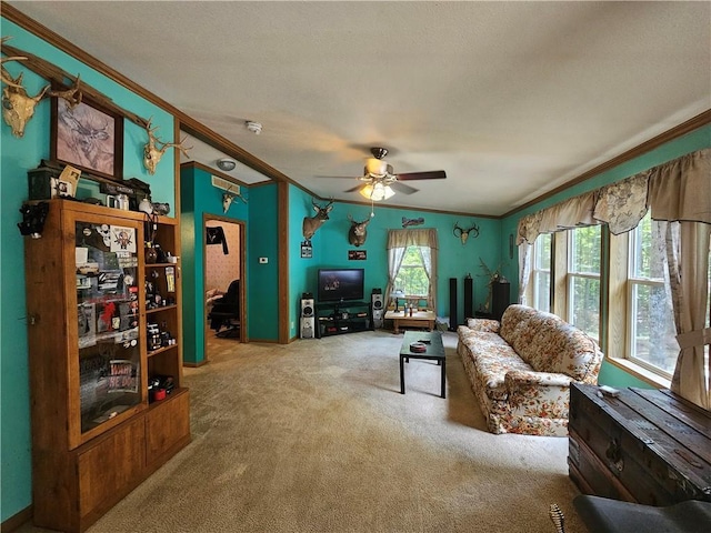 living room featuring crown molding, carpet floors, and ceiling fan