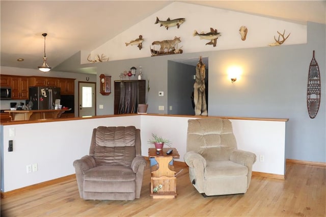 interior space with lofted ceiling and light hardwood / wood-style flooring