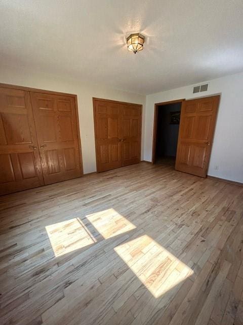 unfurnished bedroom with light hardwood / wood-style floors