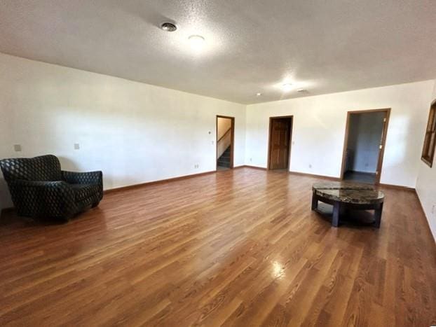 living room with dark wood-type flooring and a textured ceiling