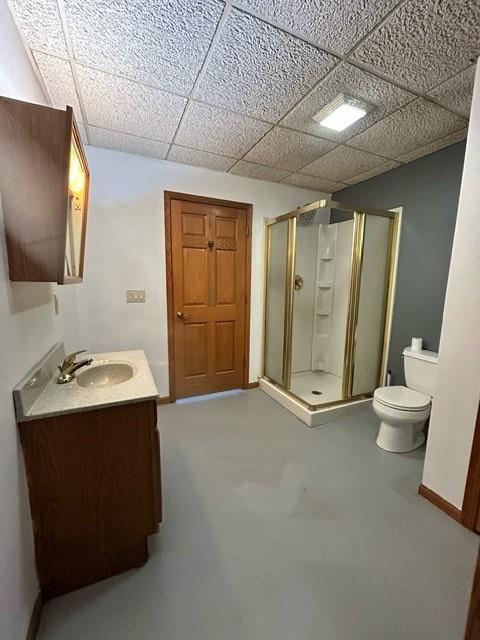 bathroom with vanity, toilet, and a shower with shower door