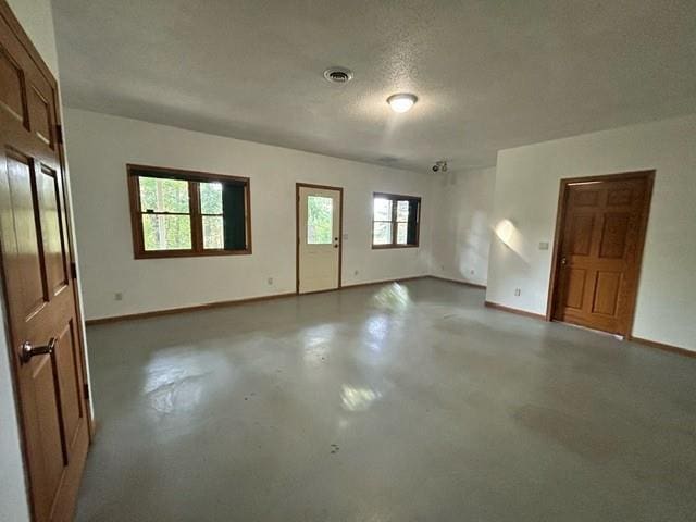 empty room featuring concrete flooring and a textured ceiling