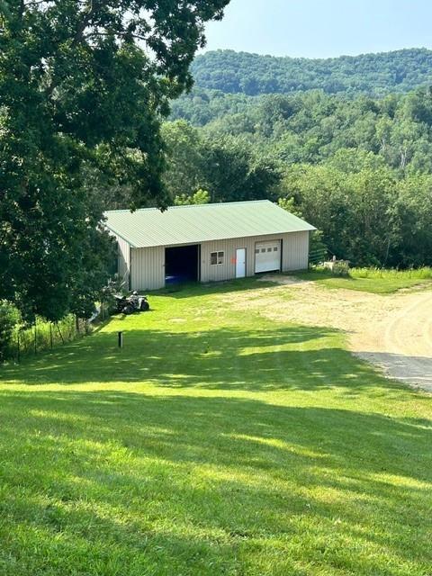 view of outbuilding featuring a garage and a lawn