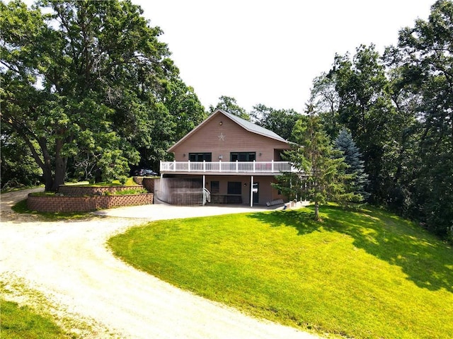 rear view of property with a yard and a deck