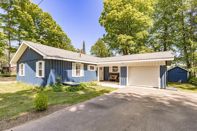 single story home featuring a garage and a front yard