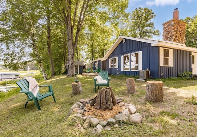 23855 Garden Lake Rd, Cable, WI 54821 - view of green lawn featuring an outdoor structure and a fire pit