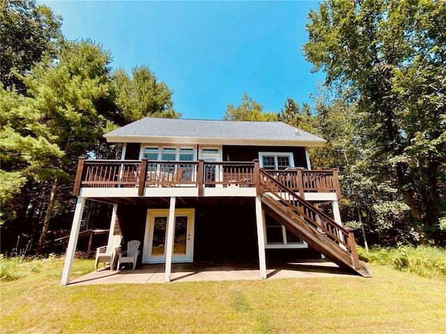 rear view of house featuring a lawn, a patio, and a deck