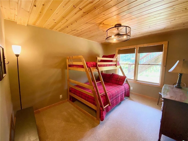 carpeted bedroom with wood ceiling