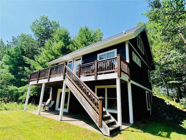 back of house featuring a patio area, a deck, and a lawn