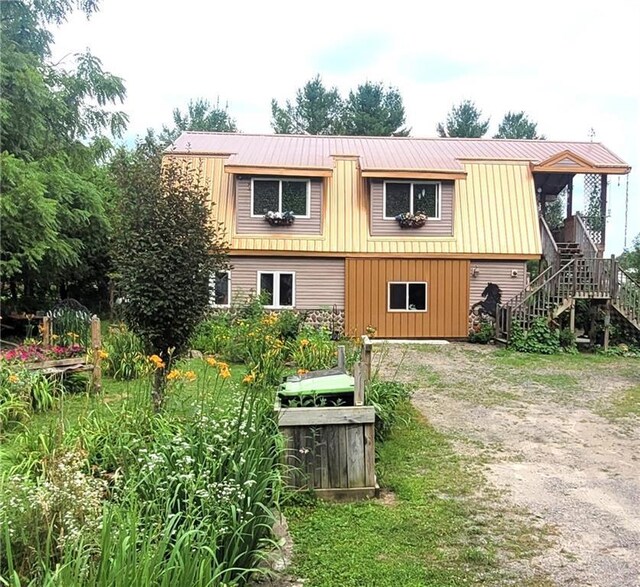 back of property featuring a deck and a lawn