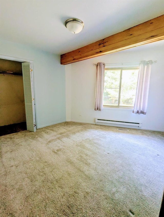 carpeted empty room with baseboard heating and beamed ceiling