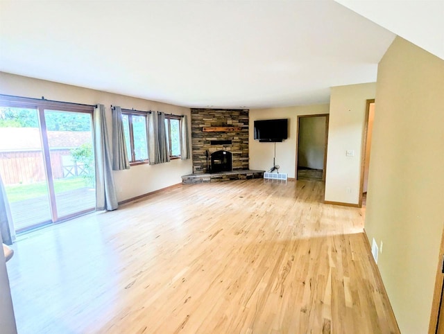 unfurnished living room featuring a fireplace and light wood-type flooring