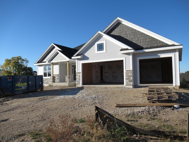 1790 Arbor Vista Pl, West Bend, WI 53095 - craftsman-style house with stone siding and gravel driveway