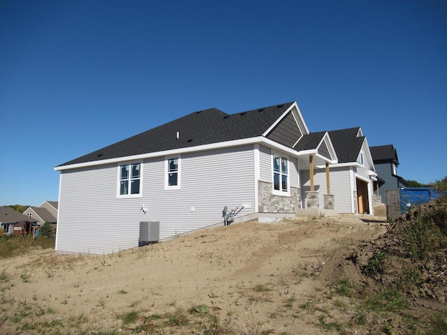 view of side of home with central air condition unit