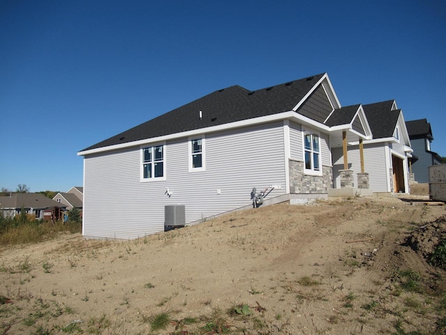 view of side of property featuring central AC