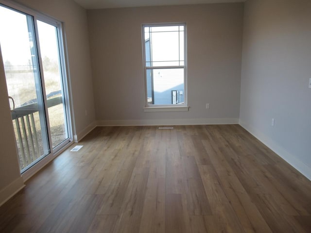 1790 Arbor Vista Pl, West Bend, WI 53095 - spare room with wood finished floors and baseboards