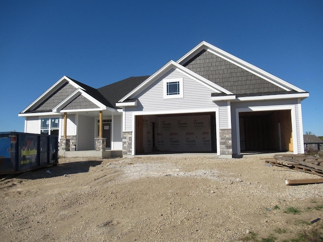 craftsman inspired home with a garage and a porch