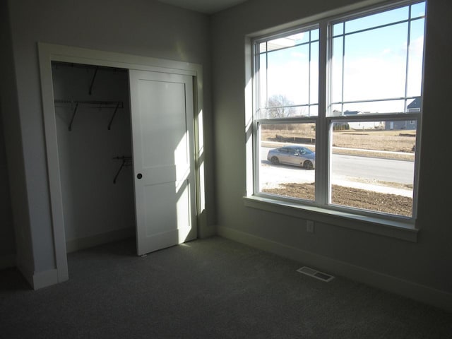 1790 Arbor Vista Pl, West Bend, WI 53095 - unfurnished bedroom with a closet, carpet, and baseboards