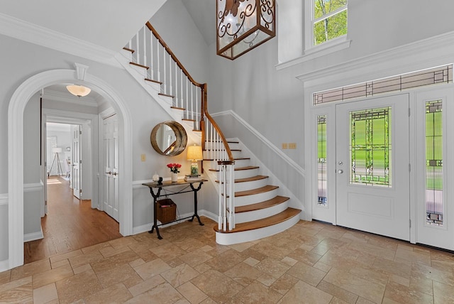 entrance foyer featuring ornamental molding