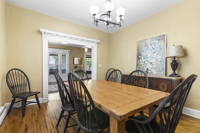 dining area featuring dark hardwood / wood-style flooring and a chandelier