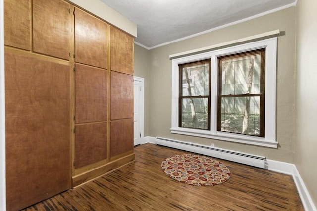 entrance foyer with crown molding, dark wood-type flooring, and baseboard heating