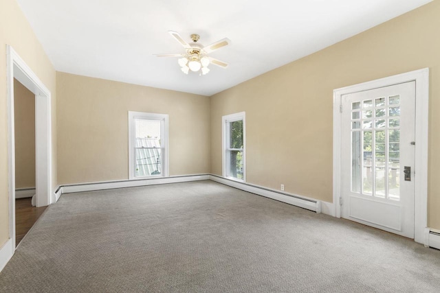 unfurnished room with a baseboard heating unit, carpet floors, and ceiling fan