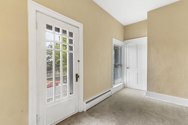 doorway featuring a baseboard heating unit and carpet flooring