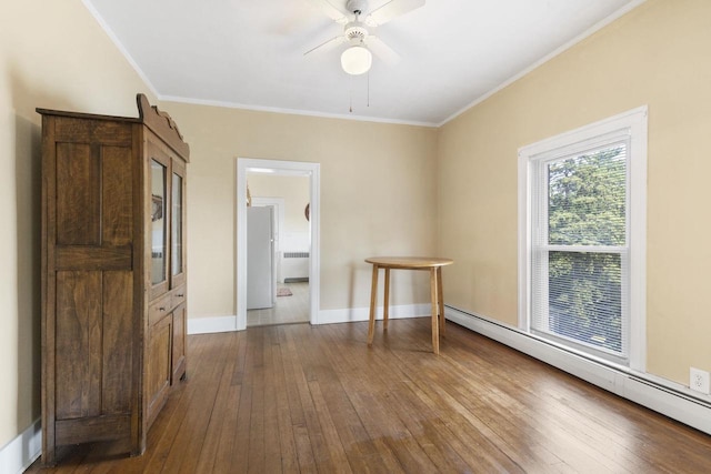 spare room with radiator, crown molding, a baseboard radiator, and hardwood / wood-style floors