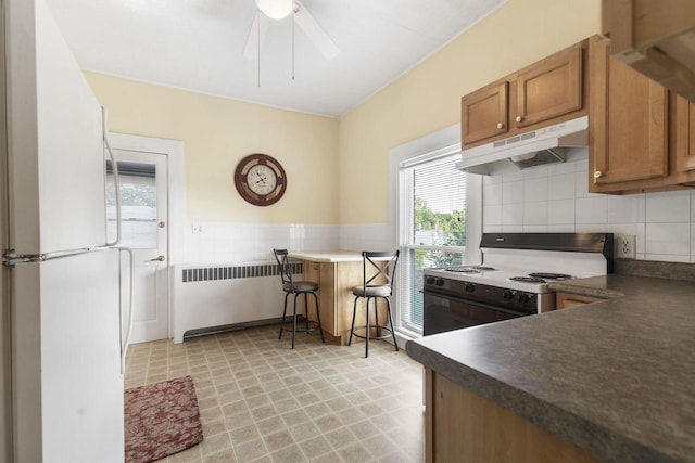 kitchen with radiator, white appliances, and ceiling fan