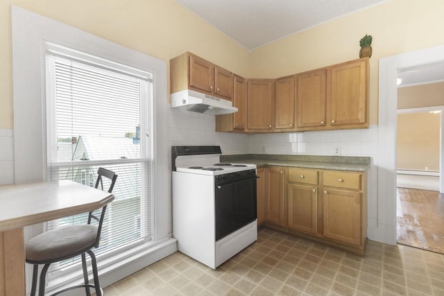 kitchen featuring range with electric cooktop, baseboard heating, and tasteful backsplash