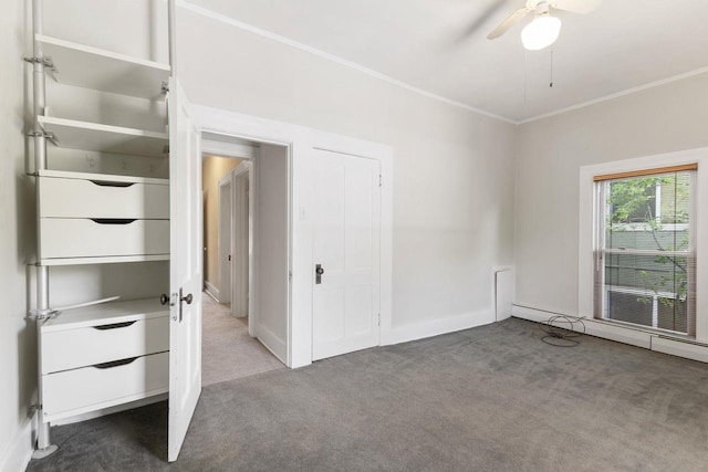 carpeted empty room with crown molding and ceiling fan