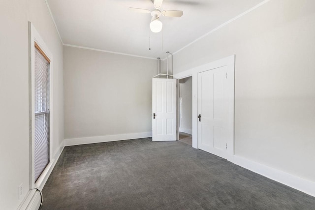 interior space featuring crown molding, a baseboard heating unit, ceiling fan, and dark carpet