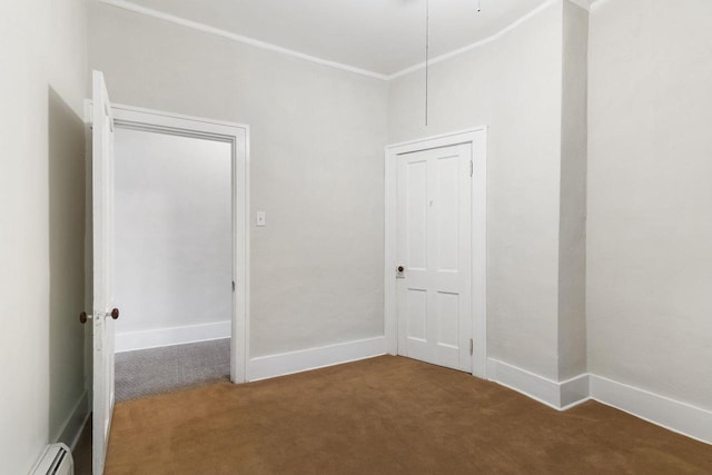 empty room with ornamental molding, a baseboard heating unit, and carpet flooring